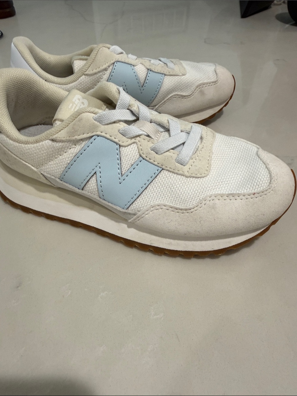 New Balance Kids White Sneakers with Light Blue 'N' Logo